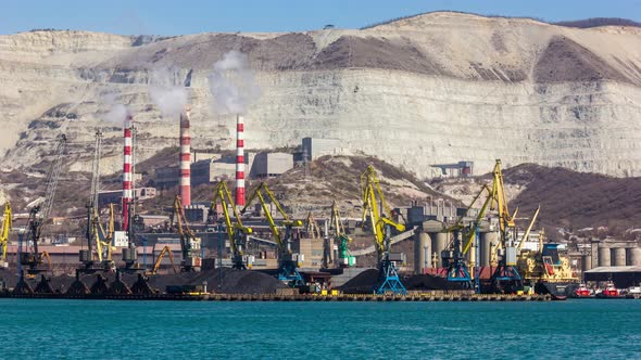 Harbor Cranes Loading Coal Next to a Quarry alt