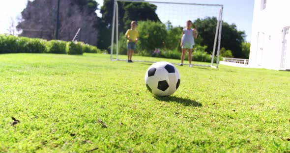 Father and kids playing football alt