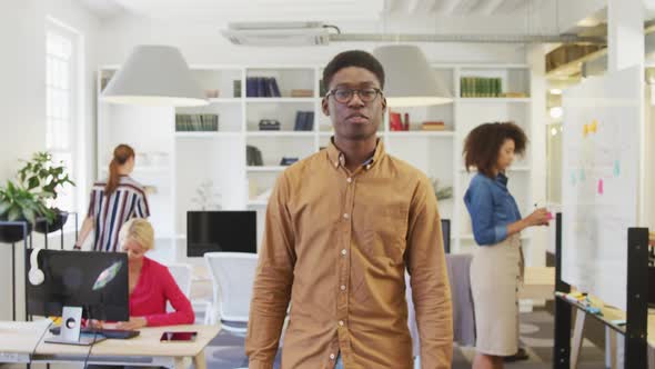 Business man smiling at the camera alt