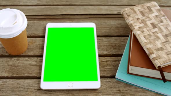 Disposable glass, digital tablet and organizer on table 4k alt