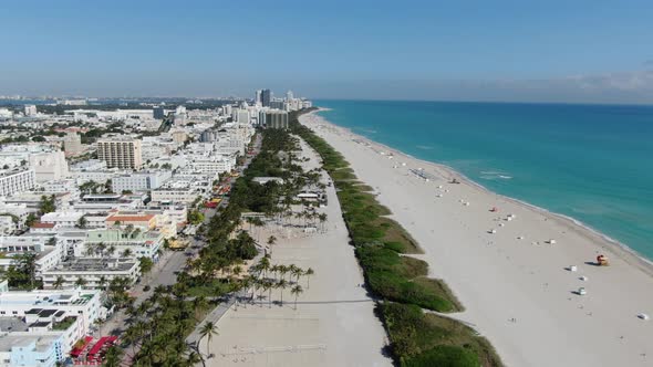 White Sand And Blue Water Of Miami Beach With Skyscrapers Of Downtown Miami In Florida. aerial, pull alt