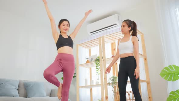 Asian active sport woman learn yoga pilates lesson with coach trainer. alt