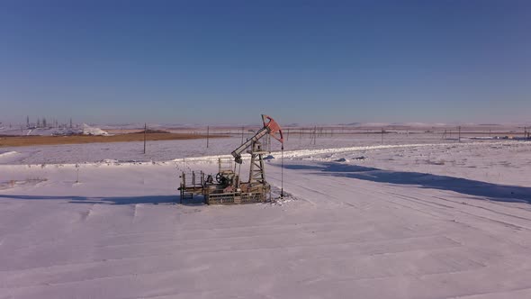 Pump Jack in Vast Oil Fields in Winter