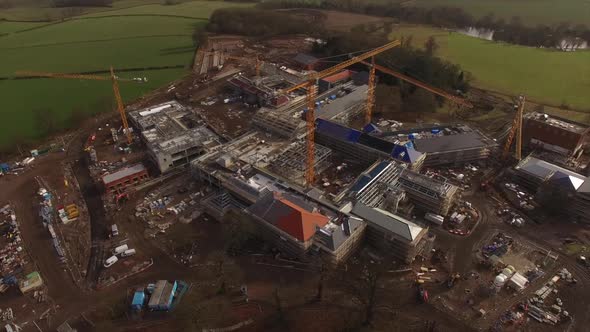 Construction And Development. Workers Building on Building site aerial Shots alt