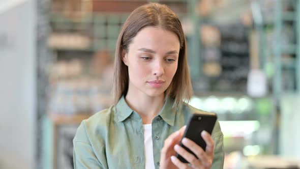 Portrait of Attractive Woman Using Smartphone  alt