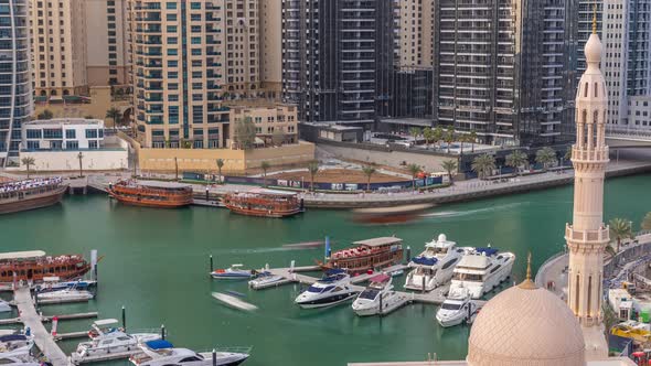 Yachts in Dubai Marina Flanked By the Al Rahim Mosque and Residential Towers and Skyscrapers Aerial alt
