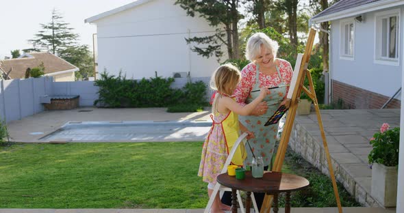 Daughter and grandmother painting on canvas 4k alt