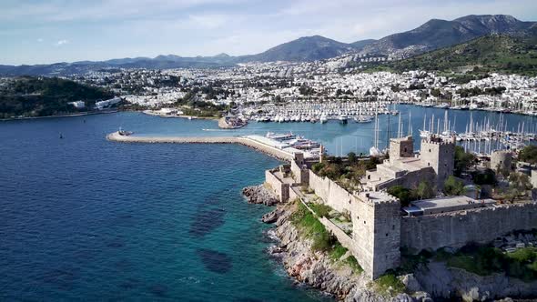 View from drone on full of yachts Bodrum harbour and ancient Kalesi castle in Mugla in Turkey alt