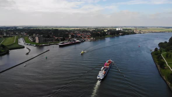 containerbarge shipping containers at a dutch river alt