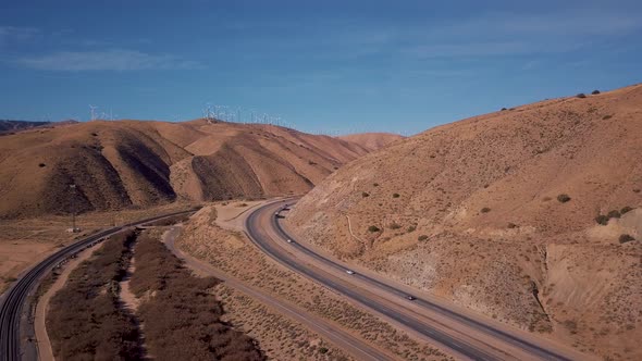 Aerial view of cars and semi trucks driving on scenic state route in California alt
