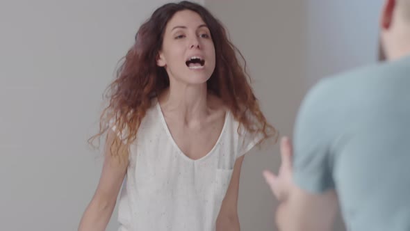 Angry Caucasian Couple Insulting Each Other in Bedroom alt