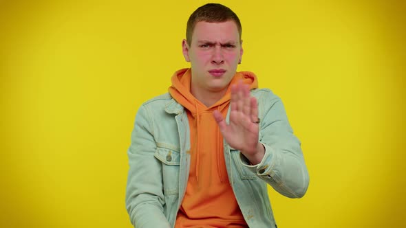 Student Man in Denim Jacket Closing Eyes Showing Stop Gesture Confused Shy Scared to Watch alt