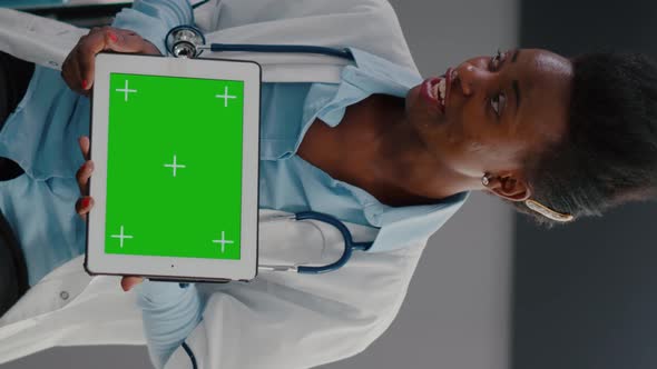 Vertical Video Doctor with Dark Skin Explaining to Woman Patient Resting in Bed About Sickness alt