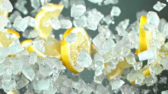 Super Slow Motion Shot of Flying Fresh Lemon Slices and Crushed Ice at 1000 Fps. alt