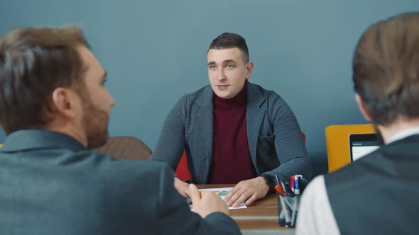 Male Businessman Tells Employees the Company's Growth Strategy alt