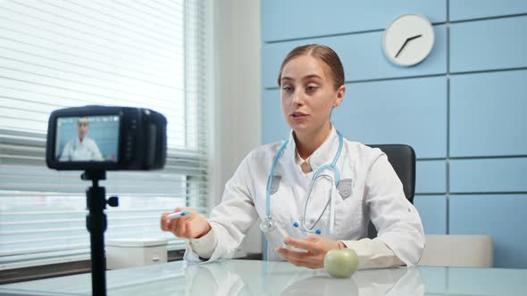 Professional medical blonde lady blogger in white coat alt