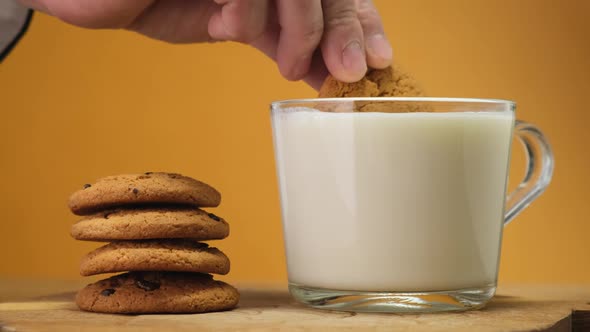 Chocolate cookies on wooden boar and glass of milk. Close up. HD