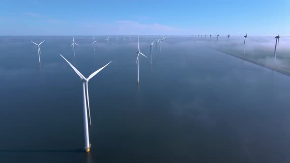 Wind Turbines in the Early Morning Wind Mill Park in the Netherlands alt