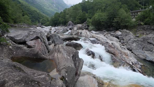 small creek in mountains in Switzerland, Valle Verzasca slow-motion waterfall rumbling water, Big Ho alt