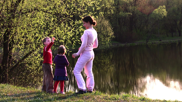 Mother With Children On Spring Pond