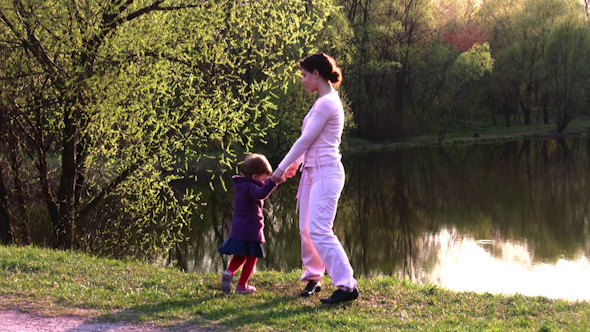 Mother With Girl On Spring Pond