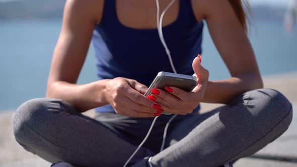 Cropped Shot of Girl Using Smartphone Outdoor alt