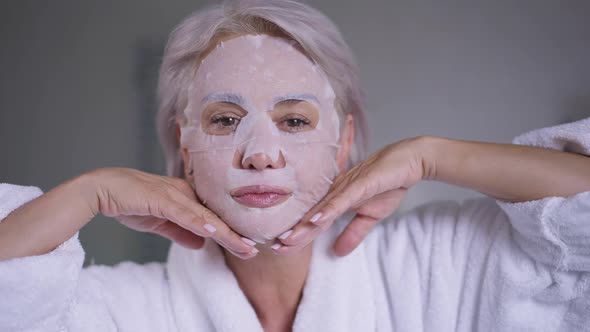 Gorgeous Middle Aged Woman in Face Mask Gesturing Air Kiss Smiling Looking at Camera alt