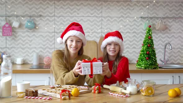 Little Girls Making Christmas Gingerbread House in Kitchen
