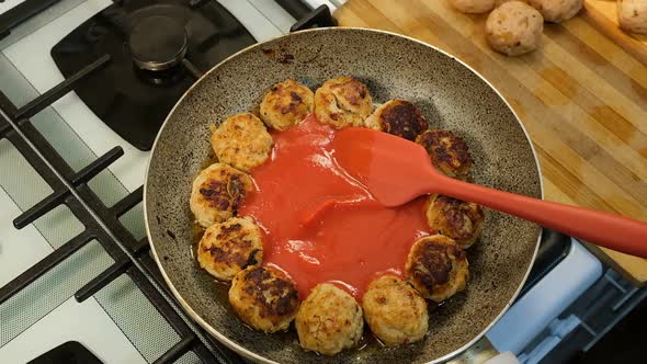 Tomato Sauce Pasta Poured On Fried Meatballs on Frying Pan