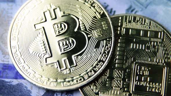 Bitcoin BTC coin rotate on 100 dollars USD bills. blockchain, mining GPU alt