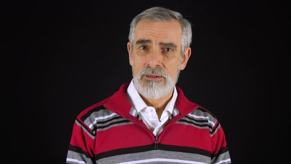 An Elderly Man Talks To the Camera - Black Screen Studio alt