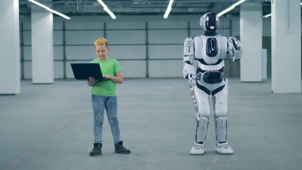 Little Boy Uses a Laptop To Control Droid, Close Up. Primary School Education Concept alt