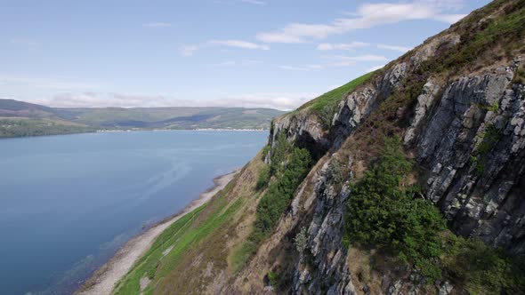 Flying Along the Coast of the Holy Isle in Scotland with Beautiful Mountains alt