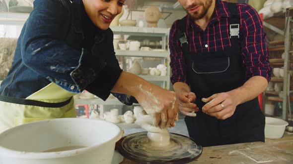 Woman and Man Have Fun In Pottery Studio