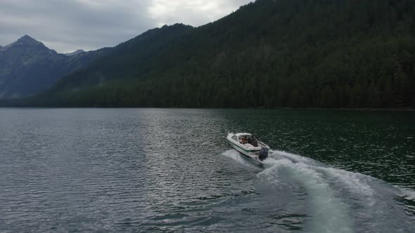 Speedboat on Multin lakes in the middle of mountains in Altai