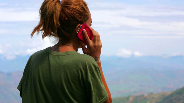 Female Tourist Using Mobile Phone at Mountain 2