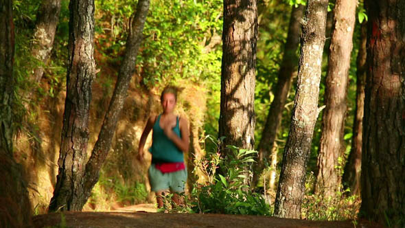 Female Tourist Running Along Narrow Footpath 3