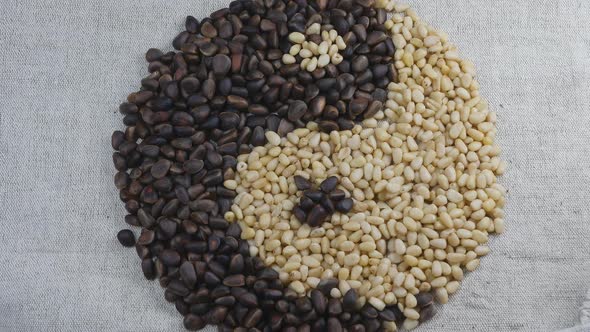 Yinyang Is Made of Peeled and Unpeeled Cedar Nuts on a Burlap Fabric