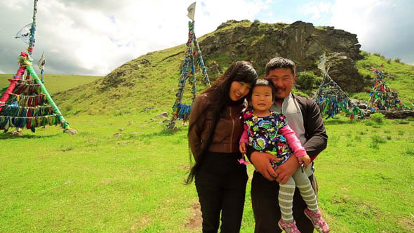 Mongolian Family In Front Of Shaman Adak