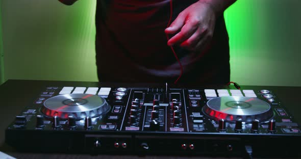 Man of DJ Tweak Various Track Controls on DJ Deck