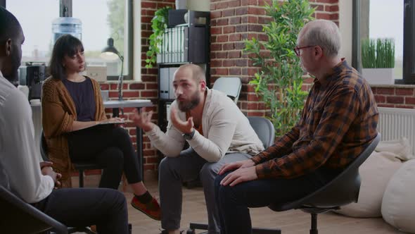 Alcohol Addict Sharing Anger Management Issues with People at Aa Rehab Meeting alt