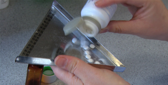 Pharmacist Measuring Tablets