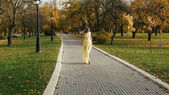 Blonde Woman Walking In The Park