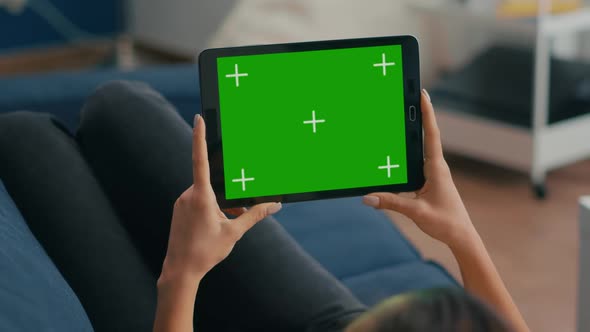 Close Up of Woman Holding in Horizontal Mode Tablet Computer alt