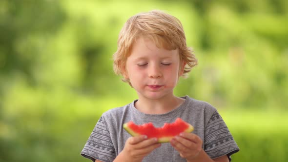Young Blond Boy Eating Watermelon
