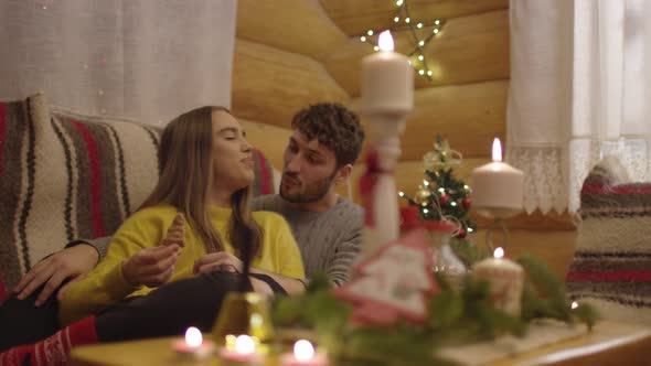 Couple eating cookies on the couch alt