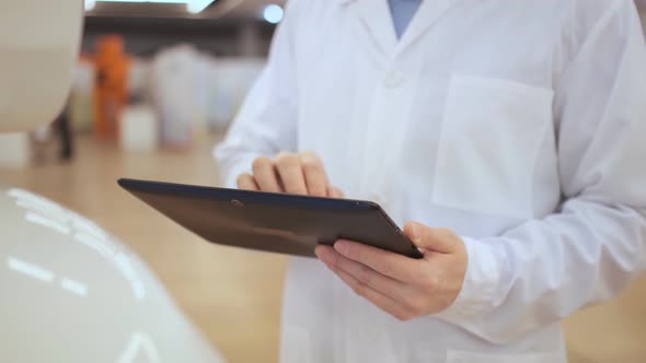 A Young Man Writes On A Robot Display. alt