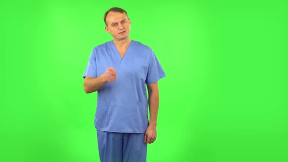 Medical Man Threatens with a Finger and Waves Her Head Negatively. Green Screen alt