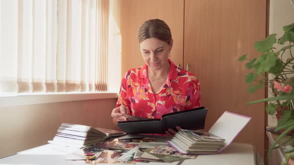 Woman Historian Middleaged Carefully Studies Archival Photographs Digs Into Historical Facts