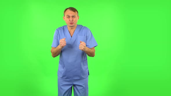 Medical Man Emotionally Watches Something, Comments and Then Rejoices in Victory, Green Screen alt